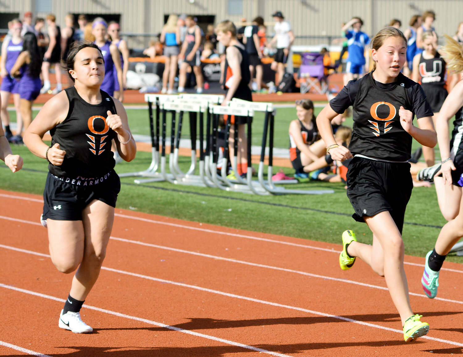 Alyvia Wilson and Abbey Quilacio (from left) race in one of five heats during the girls 100-meter dash at the annual Owensville Middle School (OMS) Relays held back on Thursday, April 13 at Dutchmen Field on the Owensville High School campus.